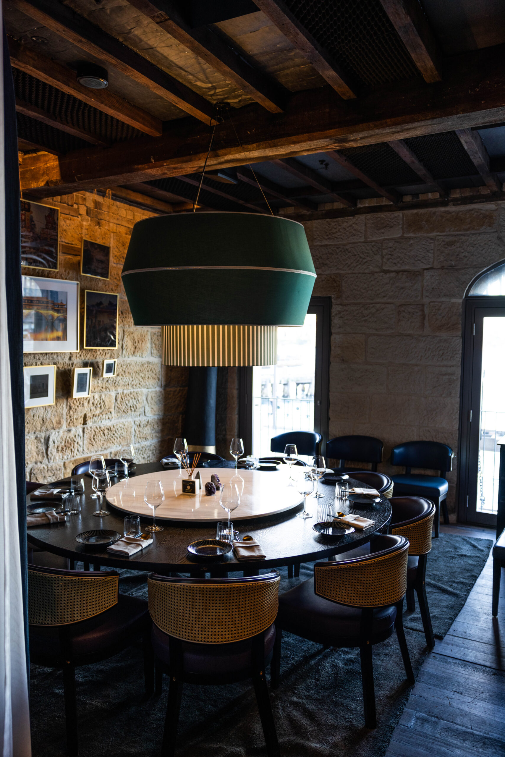 A dining table with drinks and shared dishes