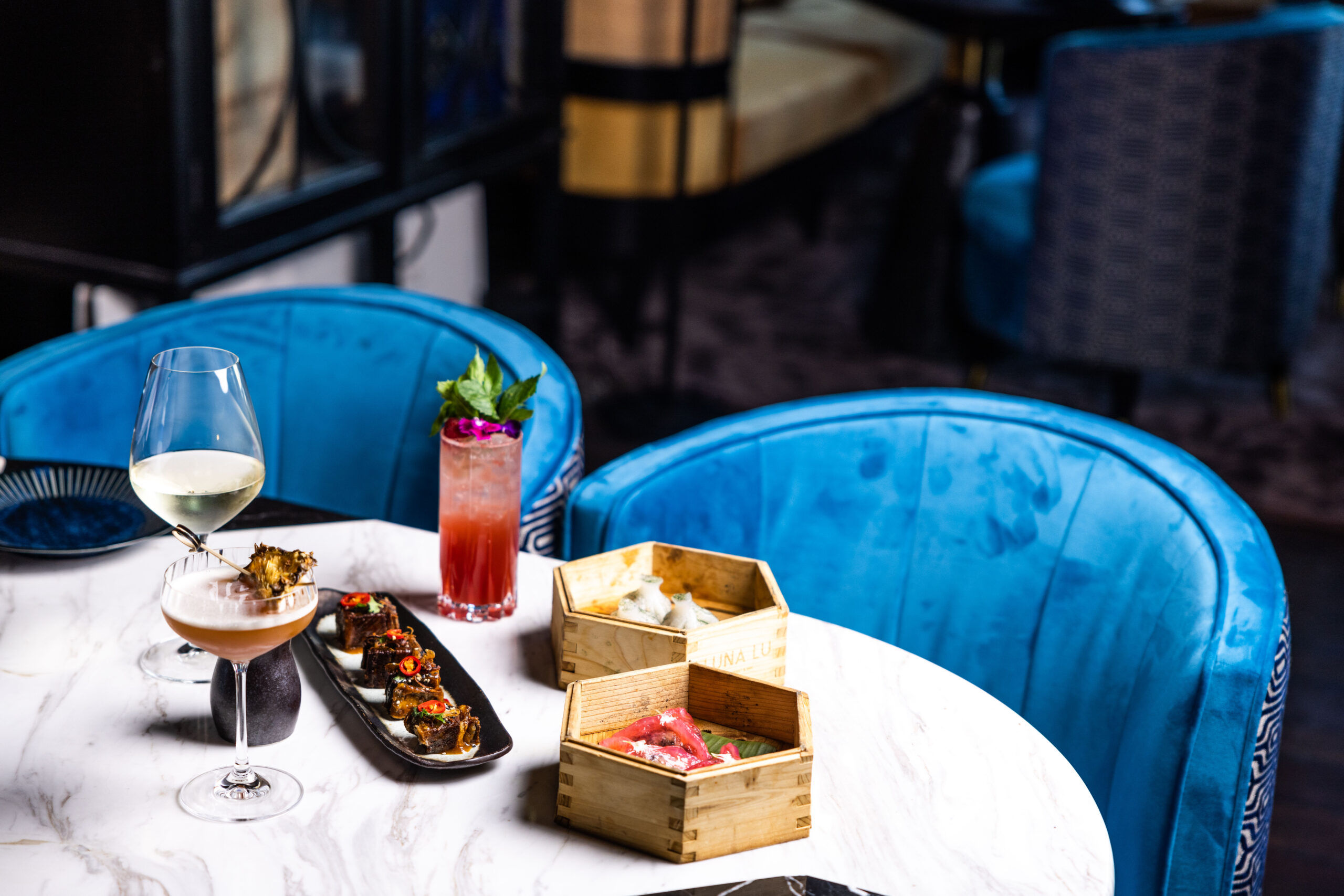 Cocktails and contemporary Asian share plates in Bar Lulu's blue lounge setting